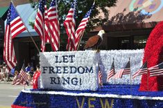 a float with american flags and an eagle on it