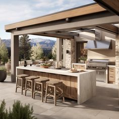 an outdoor kitchen with bar stools next to it