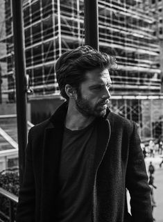 black and white photograph of a man walking down the street