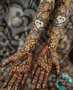 two hands with henna designs on them