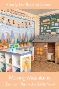 there is a small wooden house on the shelf next to bookshelves and a sign that says moving mountains classroom theme available now