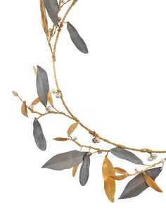 a gold and silver necklace with leaves on it