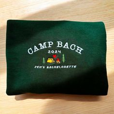 a green camp bag sitting on top of a wooden table