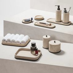 the bathroom accessories are arranged neatly on the counter