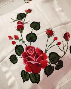 a white sheet with red roses on it