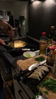 a person cooking food on top of a stove