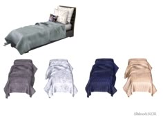 the bed is made up and has four different colored covers on it, including one with a pillow