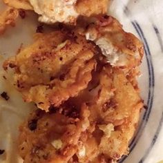 some fried food is on a blue and white plate