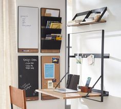 a desk with a laptop computer sitting on top of it next to a book shelf