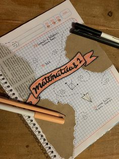 a piece of paper with the word mountain written on it and two pencils next to it