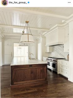 a kitchen with white cabinets and an island in the middle is featured on instagram