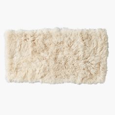 a white sheepskin rug on a white background