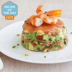 a white plate topped with shrimp and avocado