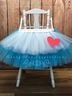 a white chair with a blue tutu and red heart on it