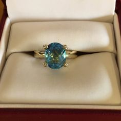 Ladies 10kt Yellow Gold Swiss Blue Topaz And Diamond Ring. Four Small Diamonds Are Set In The Prongs. Blue Swiss Topaz Is A Oval Checkerboard Cut 8 X10. Ring Size Is 5 1/4. Used But In New Condition. Topaz And Diamond Ring, Swiss Blue Topaz, Womens Jewelry Rings, Blue Gold, Blue Topaz, Topaz, Diamond Ring, Ring Size, Diamonds