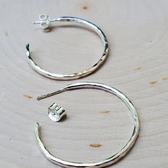 Chelsea is my open hoop stud earrings. These are classic and timeless hoops that are surprisingly lightweight and ready to take on the day! These pair well with any outfit and occasion. I offer three sizes: XSmall: diameter is approximately one-half inch Small: diameter is approximately three-quarters of an inch Medium: diameter is approximately one inch The hoops are made with slightly thicker silver wire to better show the hammered texture. These studs are on a post and come with a friction ba Simple Pierced Hoop Jewelry, Nickel-free Anniversary Hoop Earrings, Nickel Free Hoop Earrings For Anniversary, Small Hoop Earrings For Anniversary, Minimalist Round Hoop Earrings For Anniversary, Anniversary Hammered Hoop Earrings, Nickel-free Small Hoop Earrings For Anniversary, Simple Sterling Silver Hoop Earrings, Minimalist Adjustable Hoop Earrings For Anniversary