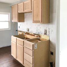 an unfinished kitchen with wooden cabinets in the process of remodeling