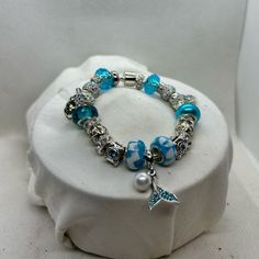 7inch Silver And Blue Rhinestone Beaded Charm Bracelet With A Mermaid Fin And Pearl Centerpiece Ocean-inspired Blue Charm Bracelet For Gifts, Silver Beaded Ocean-inspired Bracelets, Ocean-inspired Silver Beaded Bracelets, Adjustable Blue Beaded Bracelets With Rhinestones, Pandora Charms Disney, Gold Vans, Pearl Centerpiece, Lava Bead Bracelet, Bracelet Box