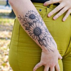 a woman with a sunflower tattoo on her arm