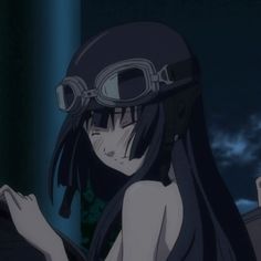 a woman with long black hair and goggles on her head is staring at something