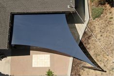 an overhead view of a house with a blue awning over the top of it