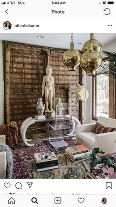 a living room filled with lots of furniture and decor on top of a wooden floor