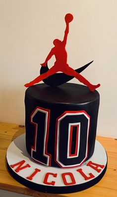 a black and red birthday cake with the number 10 on it