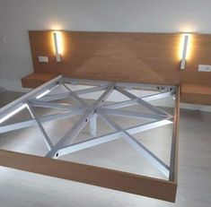 a bed with wooden headboard and lights on it