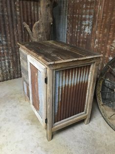 an old wooden box sitting next to a tree