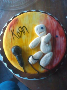 a cake that has been decorated with marshmallows and an electric microphone on it