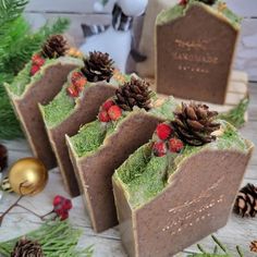 four pieces of chocolate cake with green frosting and pine cones