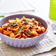 a white bowl filled with pasta on top of a table