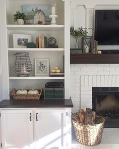 a living room filled with furniture and a fire place in front of a tv mounted on a wall