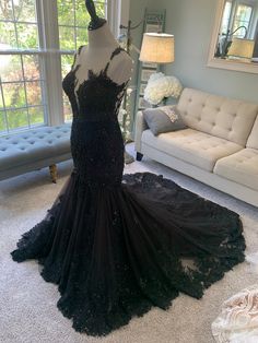 a black evening gown on display in a living room