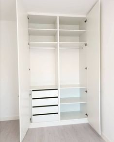 an empty closet with white shelves and drawers