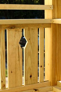 a close up of a wooden fence with the top section missing and bottom part missing