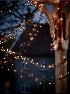 an outdoor gazebo with lights on it at night