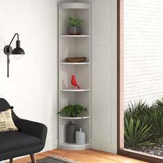 a room with a chair, potted plants and a window