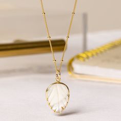 Mother of Pearl Leaf Pendant Necklace - Bridal Jewelry - Short or long necklace for layering - Bridesmaids or Bride jewelry - Pearl and Gold EARRINGS SOLD SEPARATELY Pendant Size: 20x15mmStone: Genuine Mother of PearlPlease note due to nature of our... White Crystal Necklace With Delicate Chain For Gifts, White Crystal Necklace With Delicate Chain As Gift, White Dainty Long Necklace, Dainty White Long Necklace, Gold Wire Wrapped Necklace With Oval Pendant, Gold Wire Wrapped Oval Pendant Necklace, Gold Wire Wrapped Crystal Necklace, Gold Necklace With Wire Wrapped Oval Pendant, Gold Oval Pendant Necklace Wire Wrapped