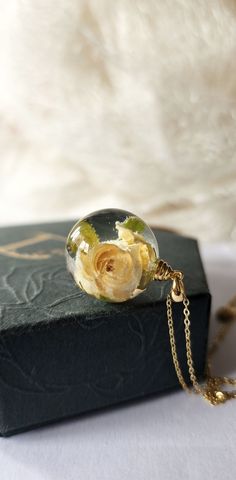 Handmade necklace, made by myself. Necklace made using real tiny white rose and bio organic resin. Chain and findings are from 925 sterling silver 18k gold plated. Pendant dimensions: 20 mm sphere ball Jewellery comes in a unique handmade gift box and will be wrapped with care so it is ready as a gift for yourself or someone special. Jewellery are one of a kind and therefore there might be slight difference between images and the product you will receive. Any questions, please do not hesitate to Delicate Rose Gold Keepsake Jewelry, Resin Pendant Jewelry With Birth Flower, Resin Birth Flower Pendant Jewelry, Handmade Rose Flower Pendant Jewelry, Handmade Delicate Rose Jewelry, Delicate Handmade Rose-colored Jewelry, Dainty Handmade Rose Jewelry, Delicate Rose Design Jewelry Gift, Handmade Rose Jewelry For Anniversary