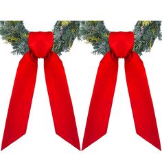 two red bows with pine branches on them