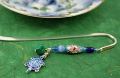 a close up of a spoon on a table with a plate and other items in the background