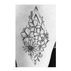 a black and white tattoo with flowers on the back