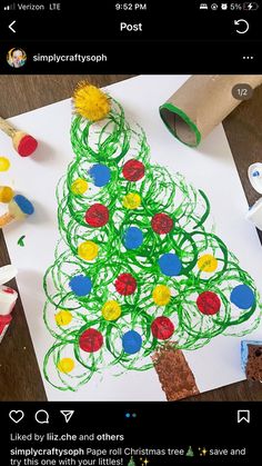 a child's drawing of a christmas tree on paper with colored crayons