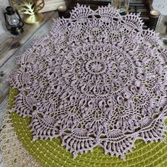 crocheted placemats are sitting on top of doily