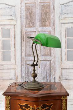 a green lamp on top of a wooden box