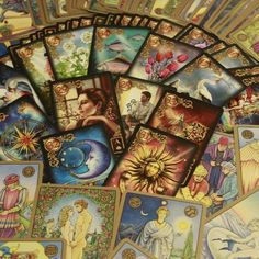 many tarot cards are laying on top of each other