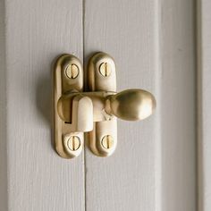 a close up of a door handle on a white door