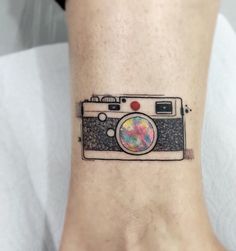 a camera tattoo on the ankle