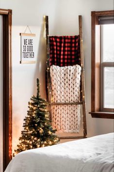 a christmas tree sitting next to a ladder